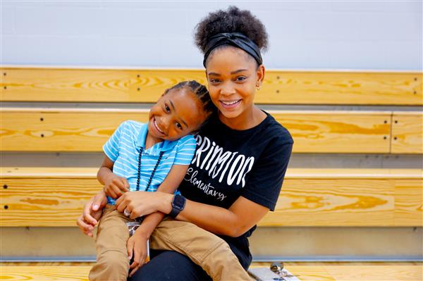 mom and son smiling in bleachers